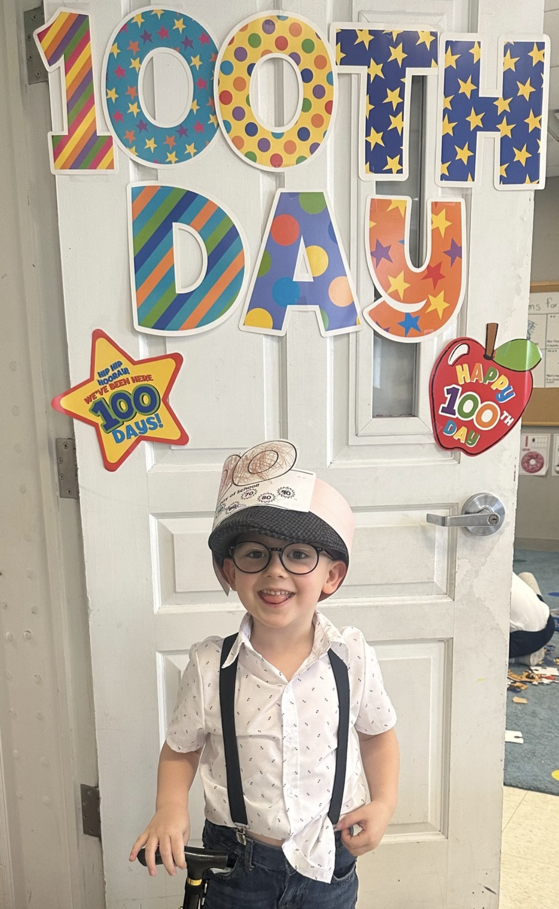 Young boy standing proudly and smiling