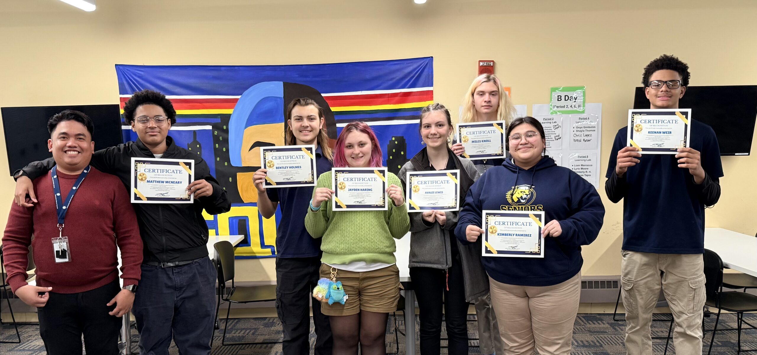 Students proudly holding up their awards