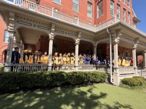 Graduates infront of a school building