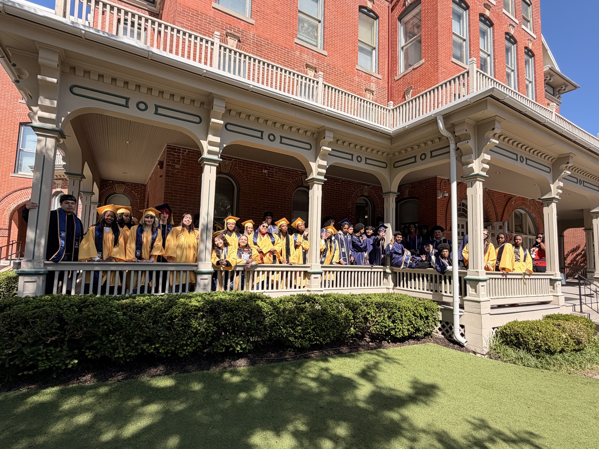 Graduates infront of a school building