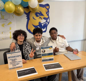 Students posing at a table in the classroom