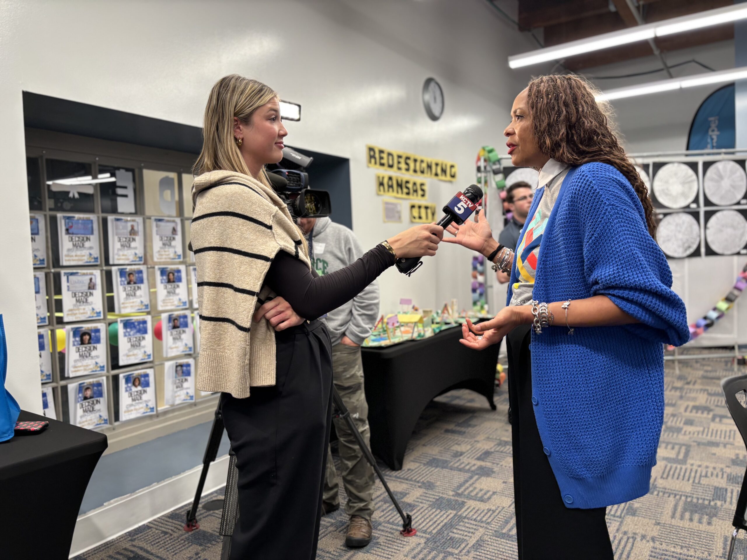 Teacher talking into a microphone for a news interview